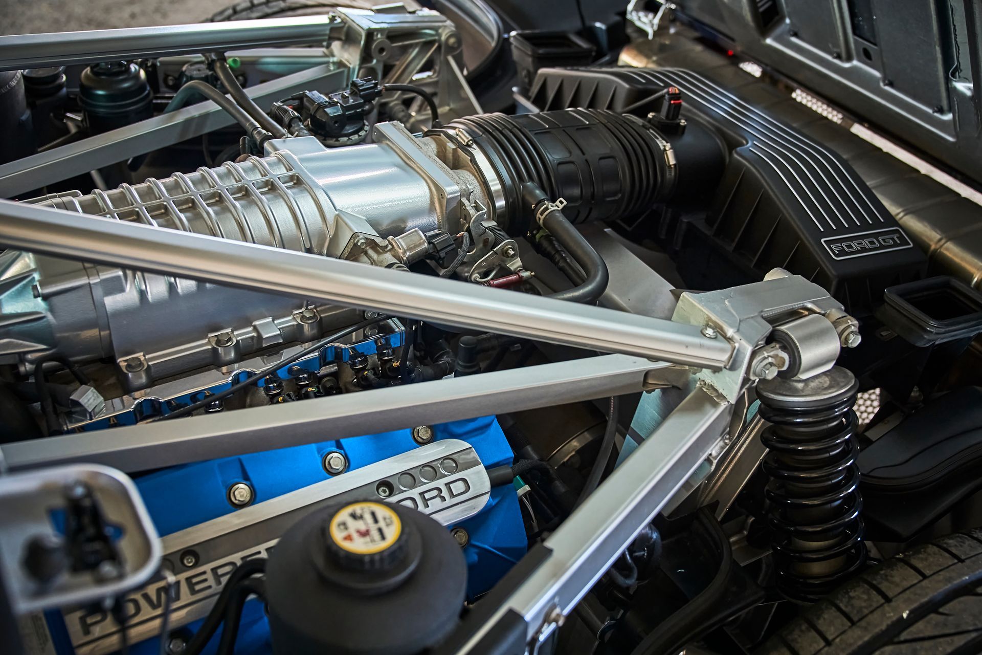 A close up of a ford engine with the hood open