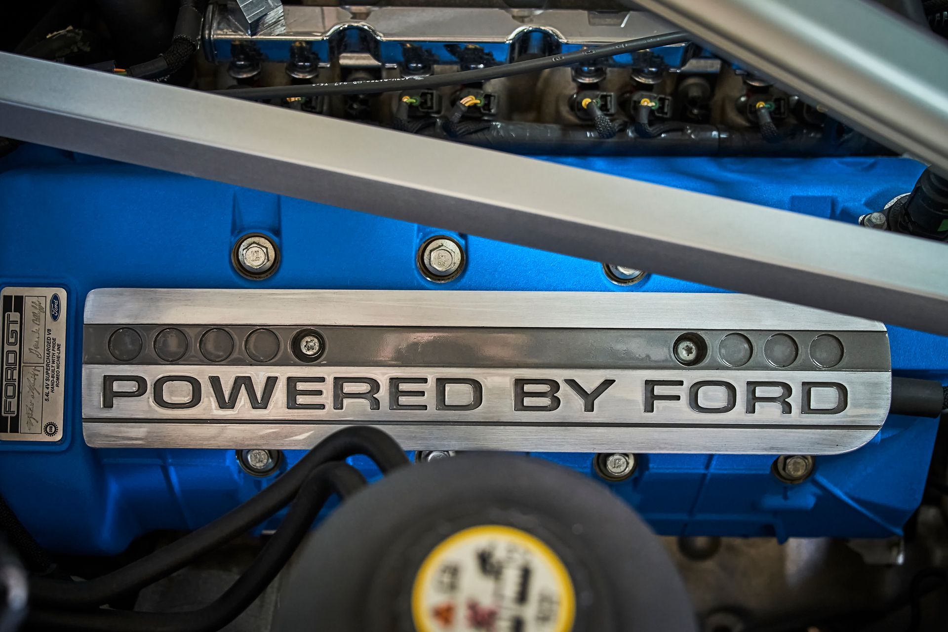 A close up of the engine of a ford car