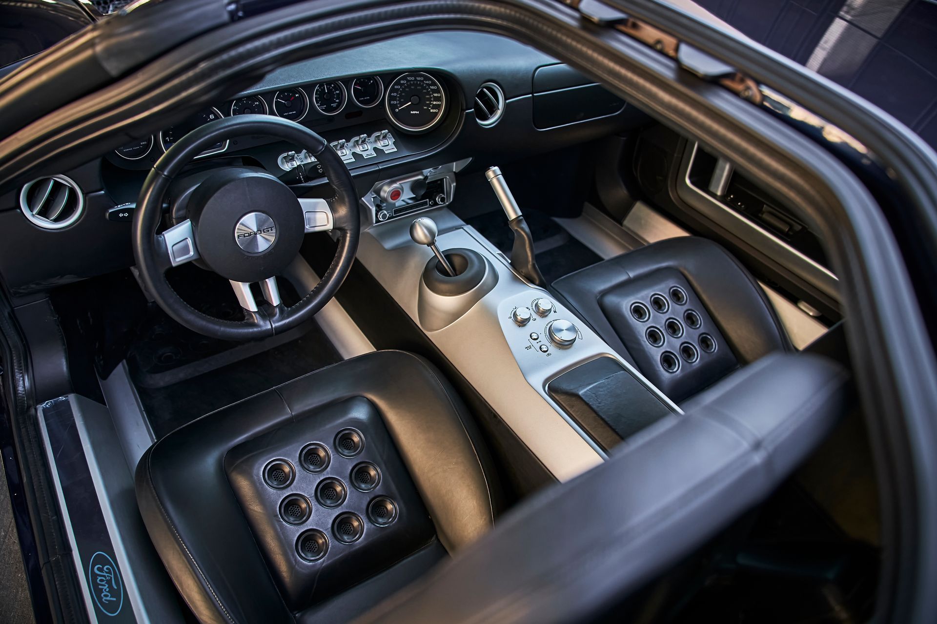 The inside of a ford car with the door open