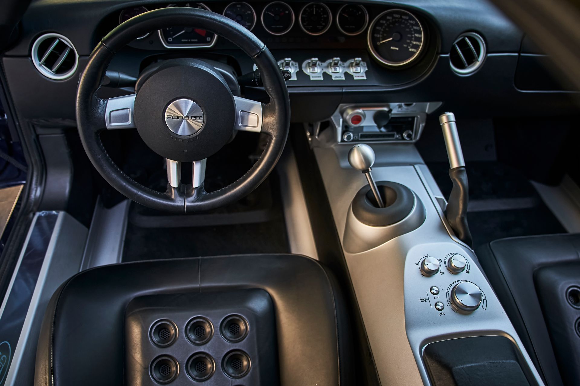 The inside of a car with a steering wheel and dashboard