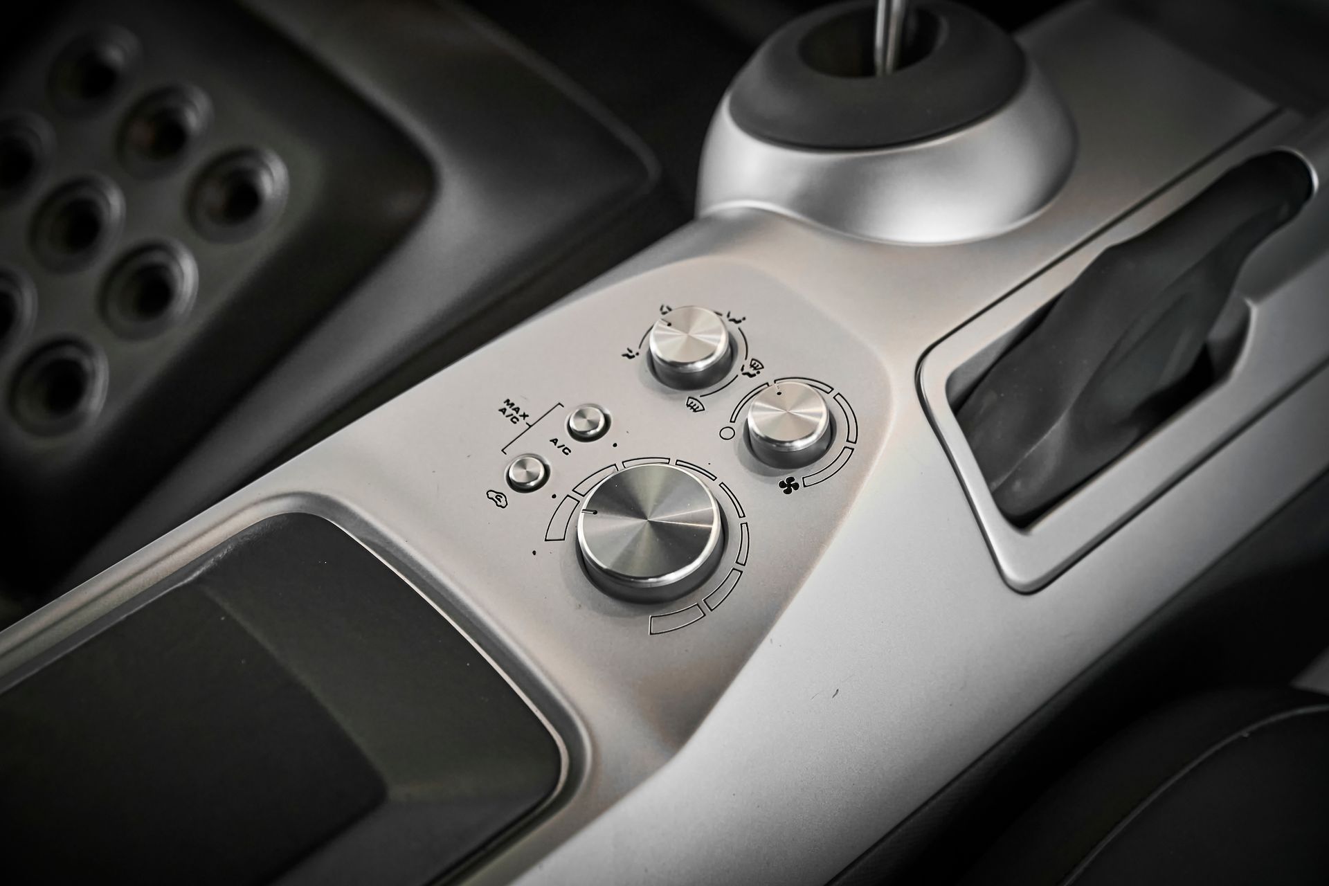 A close up of a car dashboard with a few buttons on it