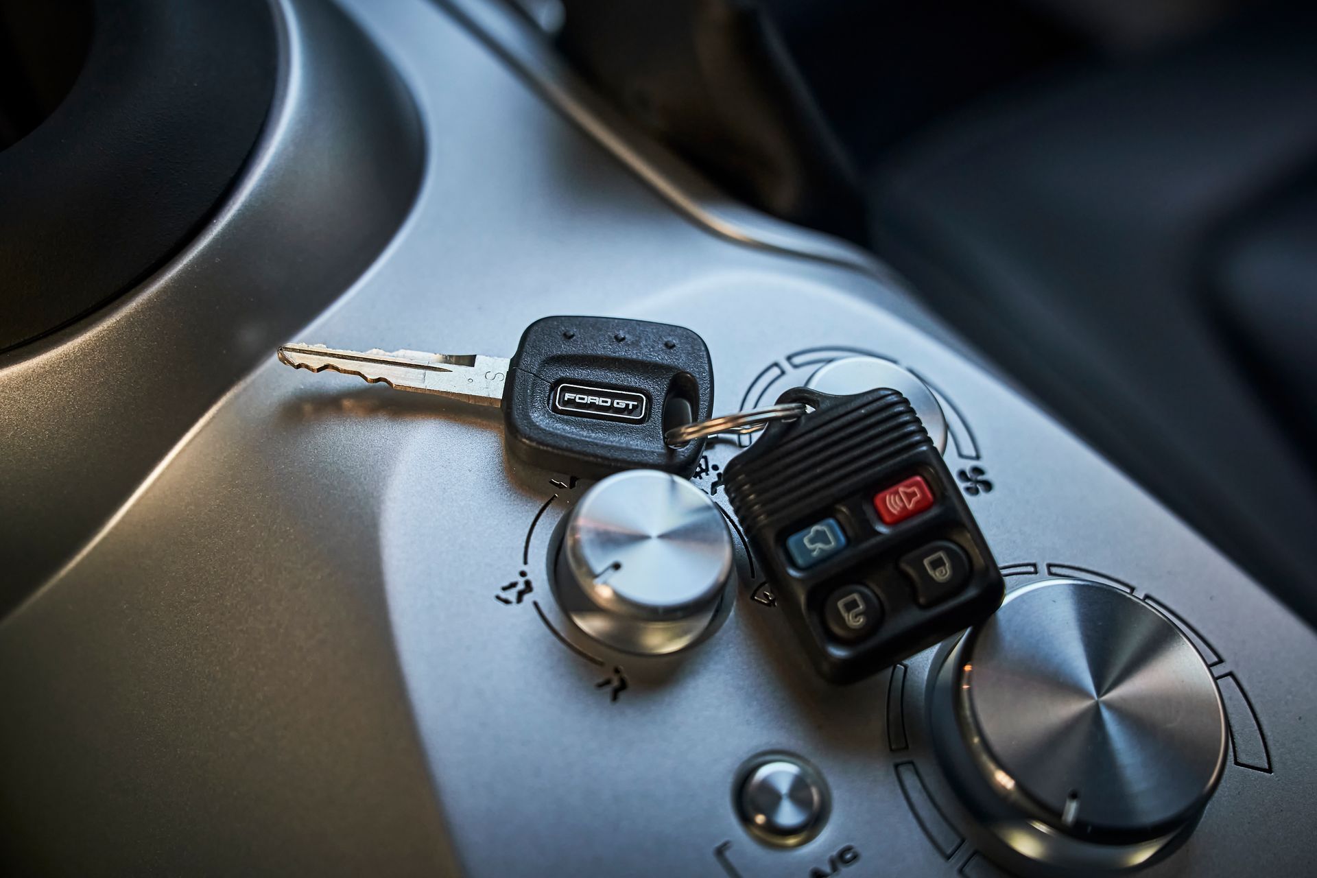 A car key is sitting on top of a control panel.