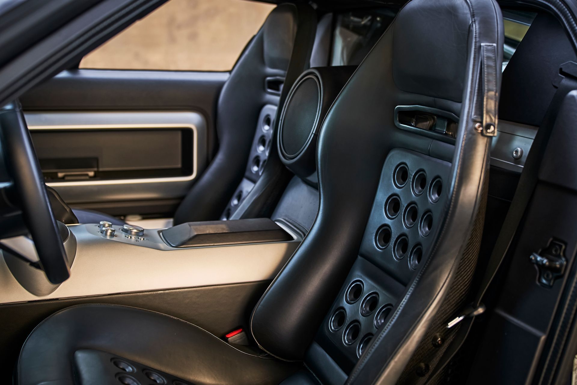 A close up of a car seat with holes in it