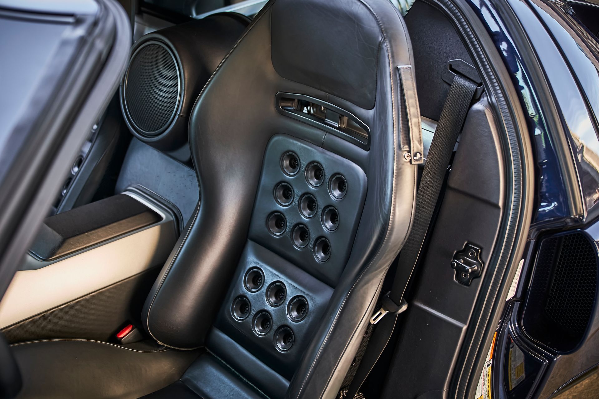 A close up of a car seat with holes in it
