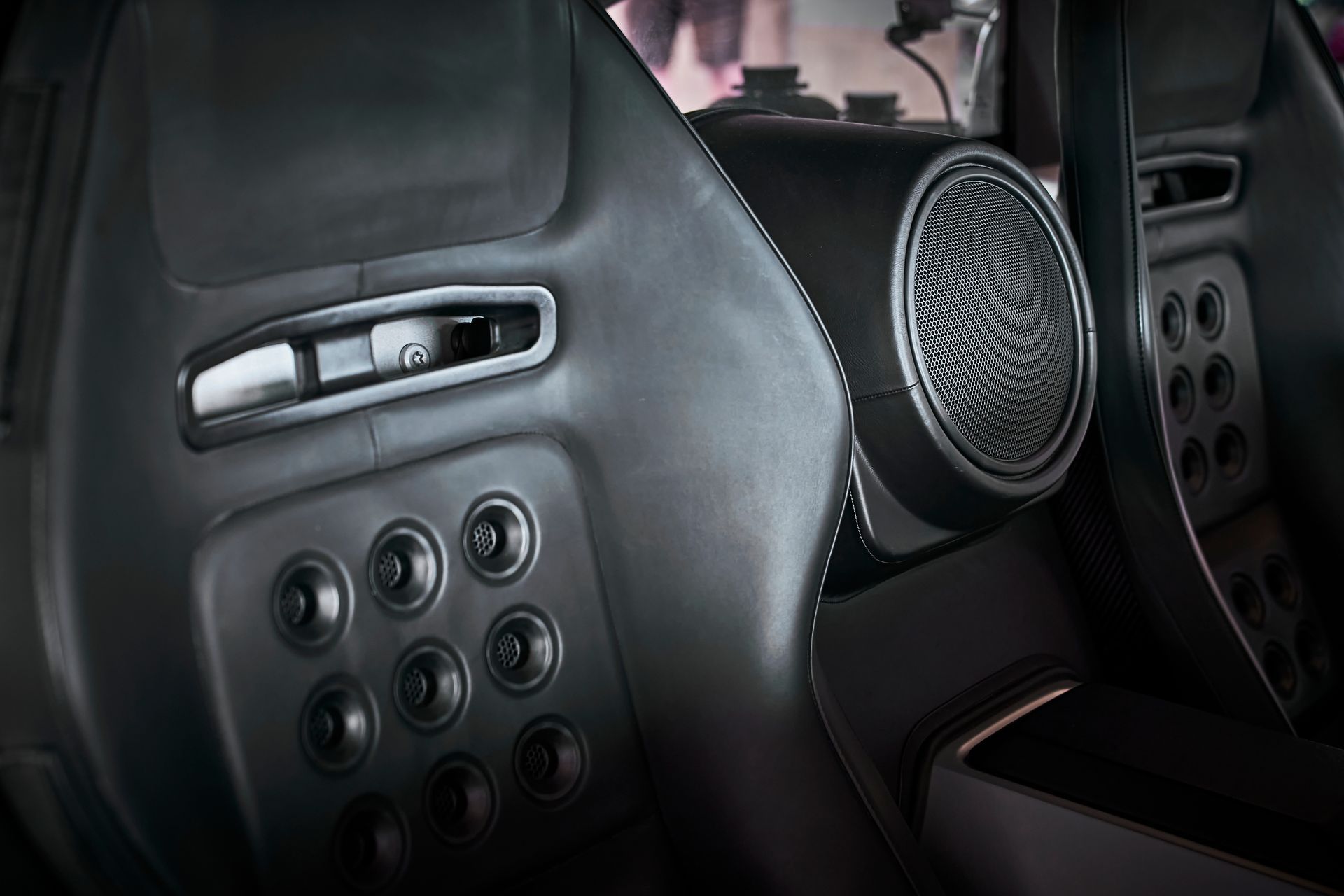A close up of the interior of a car with speakers and buttons