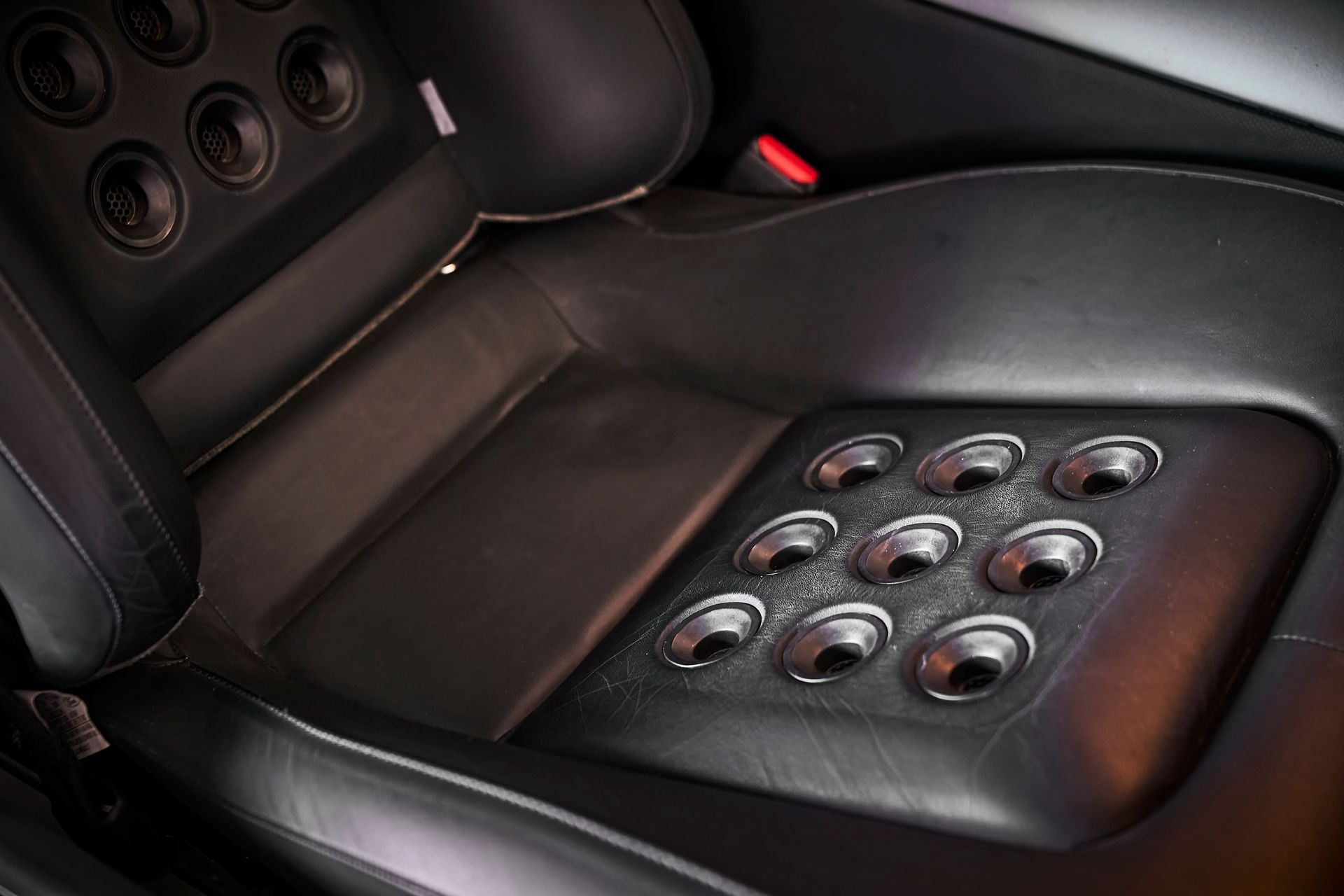A close up of a car seat with speakers on it.