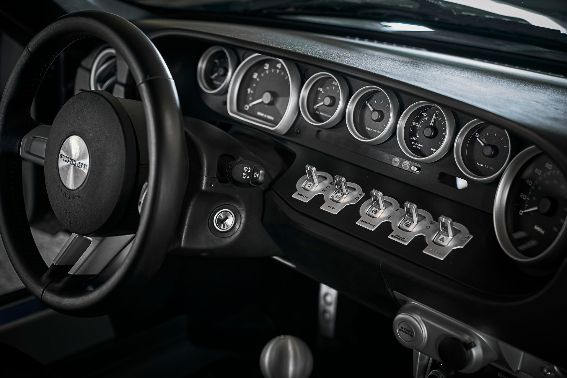A close up of a car dashboard with a steering wheel