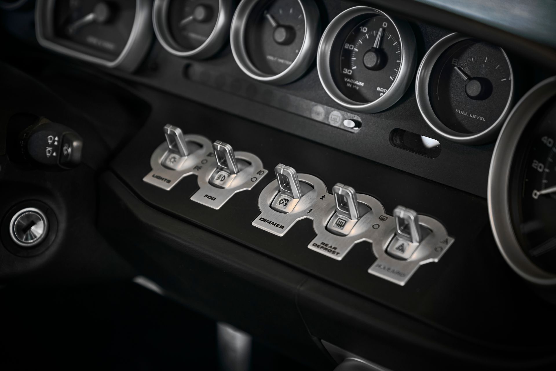 A close up of a car dashboard with a bunch of gauges