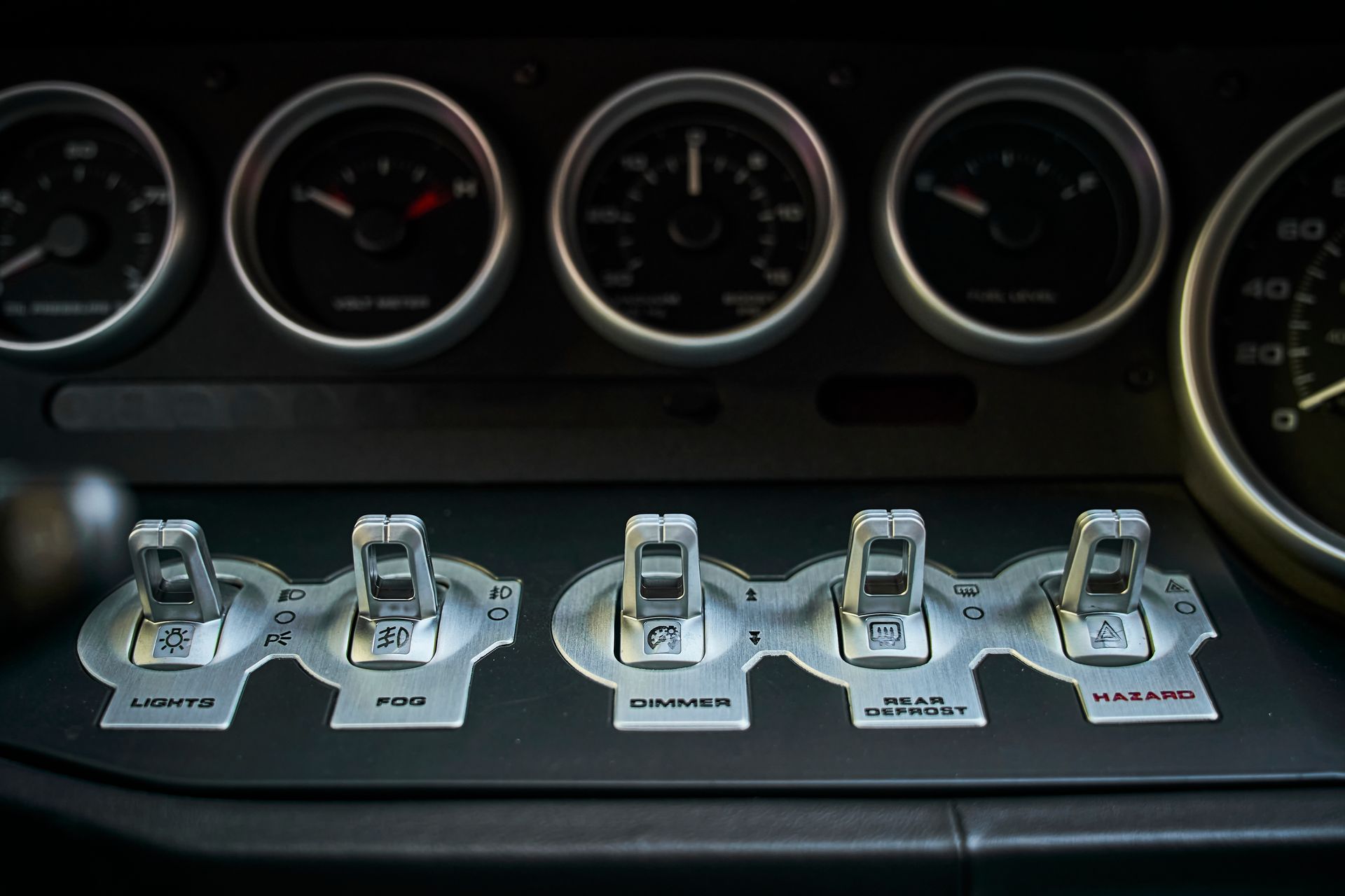 A close up of a car dashboard with a few buttons on it