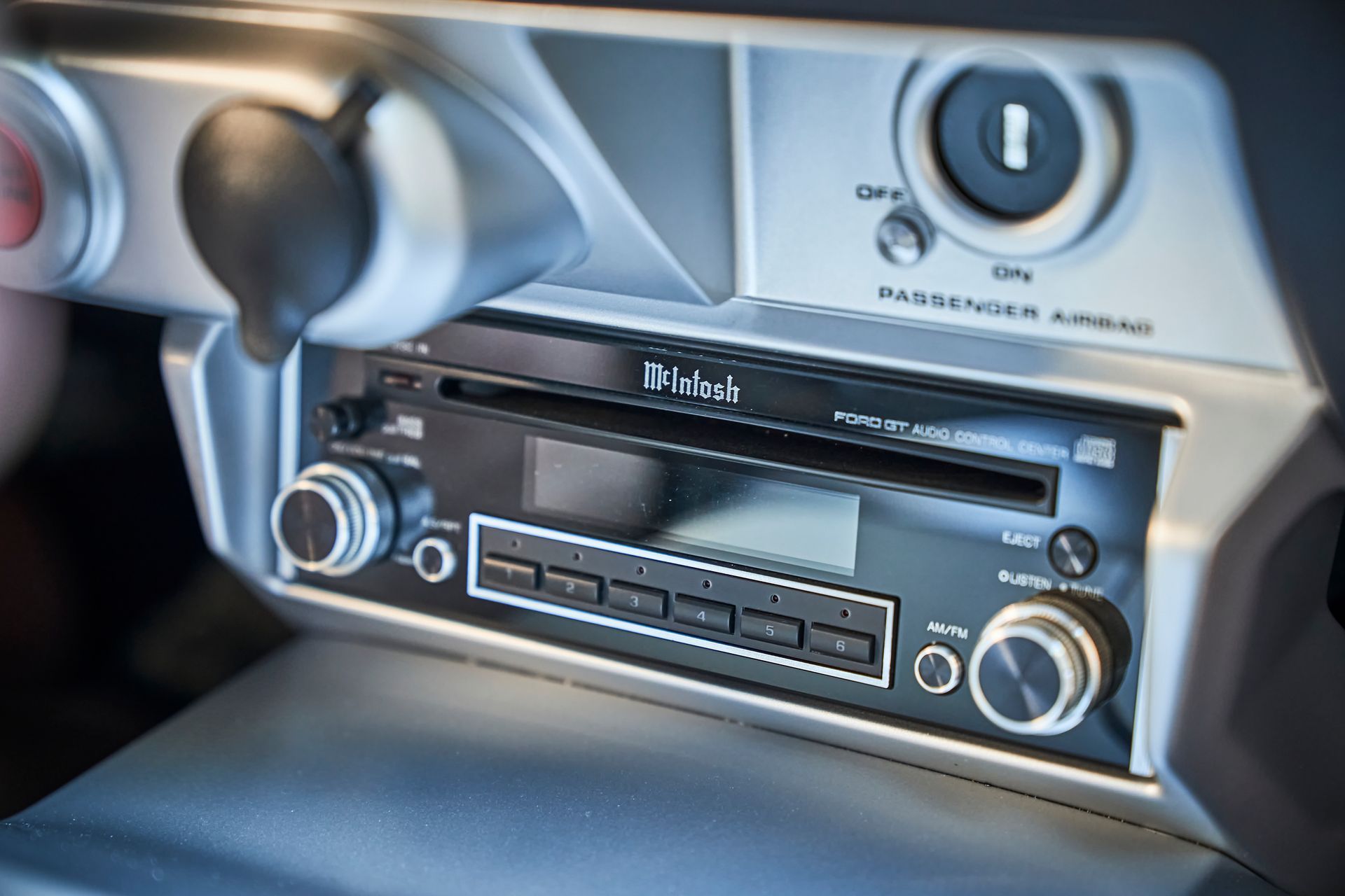 A close up of a mcintosh radio in a car