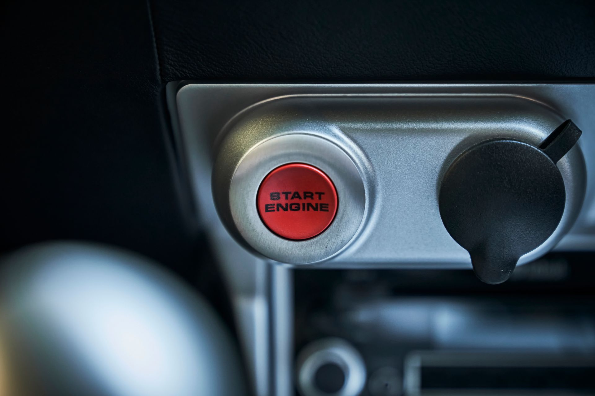 A close up of a car 's start engine button