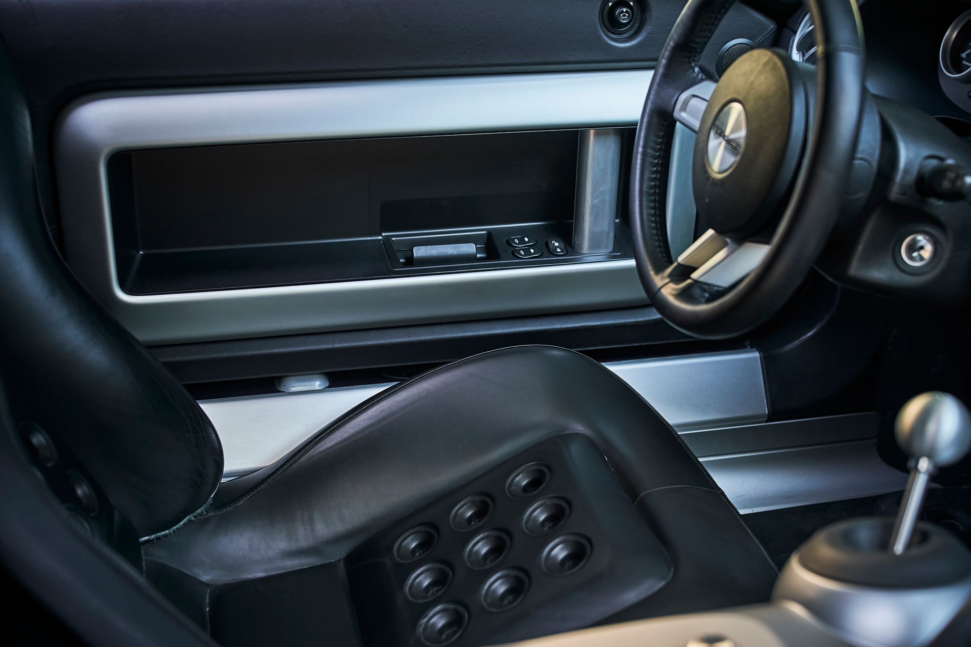 A close up of the interior of a car with a steering wheel