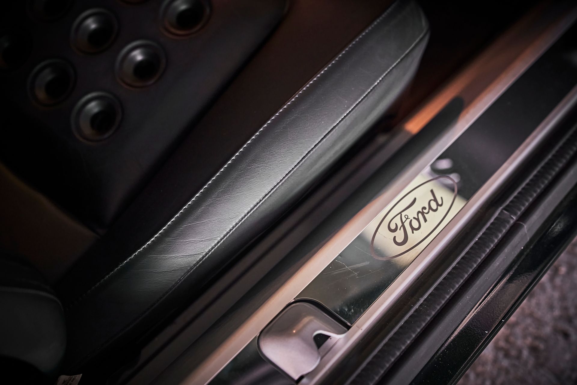 The word ford is on the door sill of a car