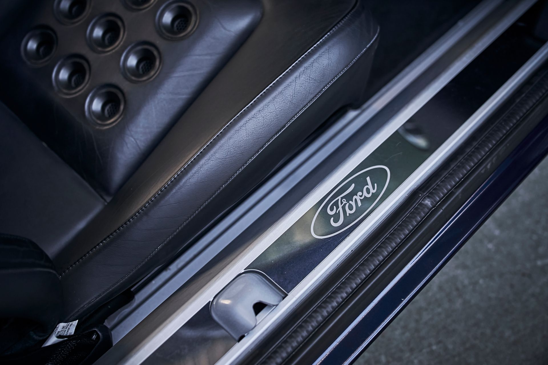 A close up of a ford logo on the side of a car