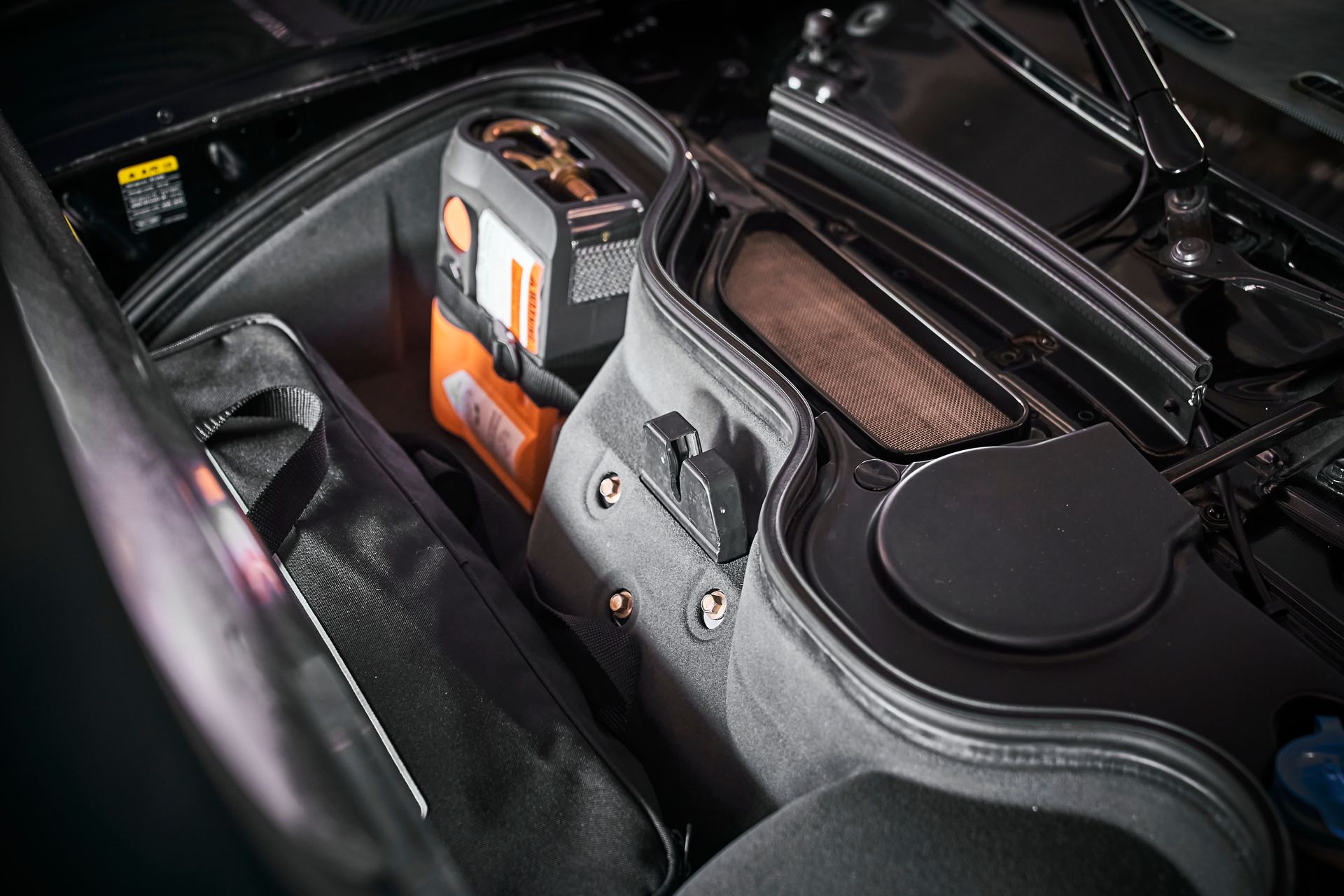 A bag is sitting in the trunk of a car.