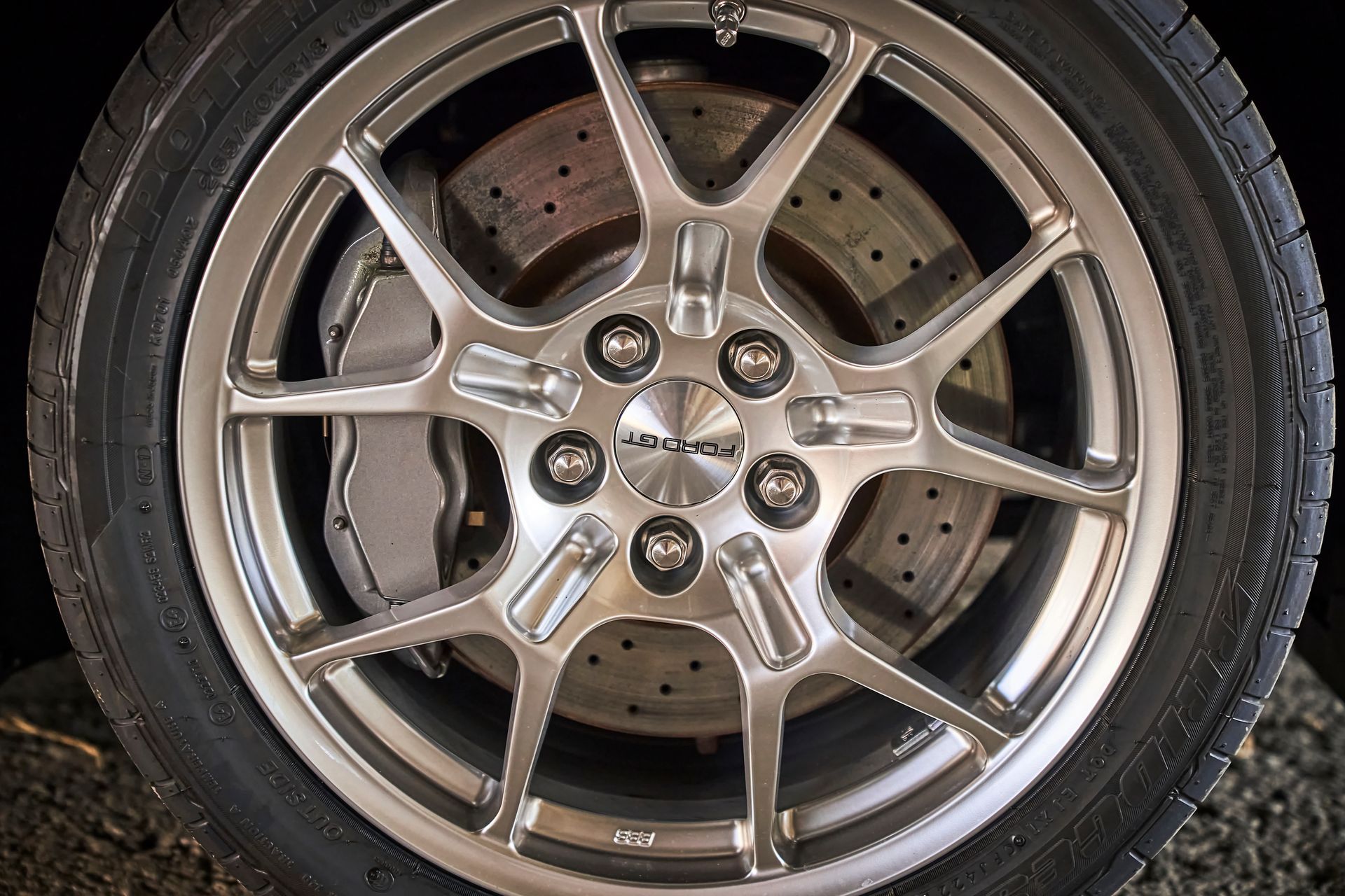 A close up of a car wheel with a tire on it