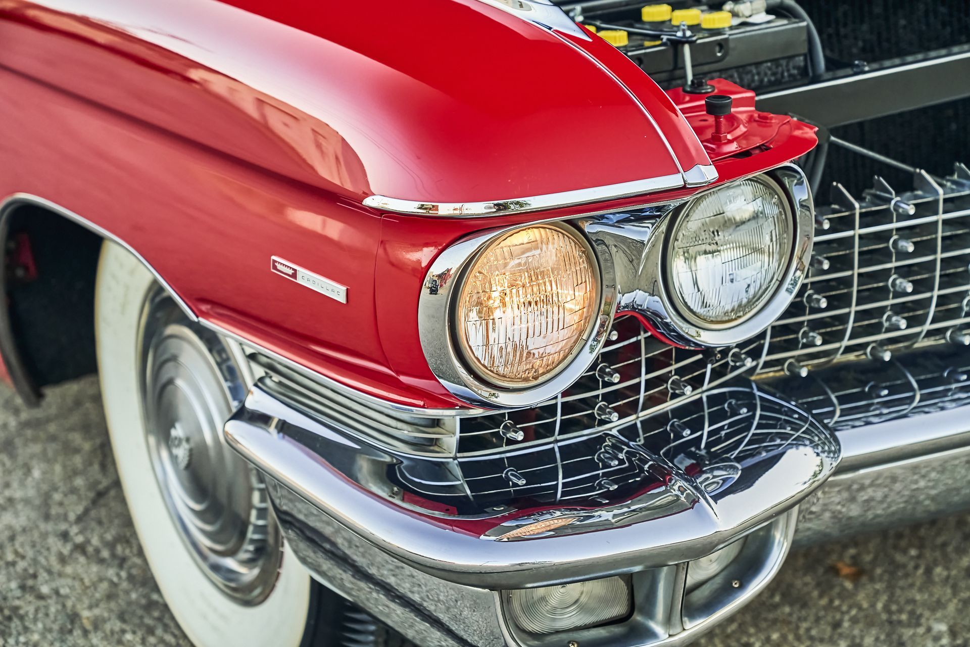 A close up of a red car with the hood open