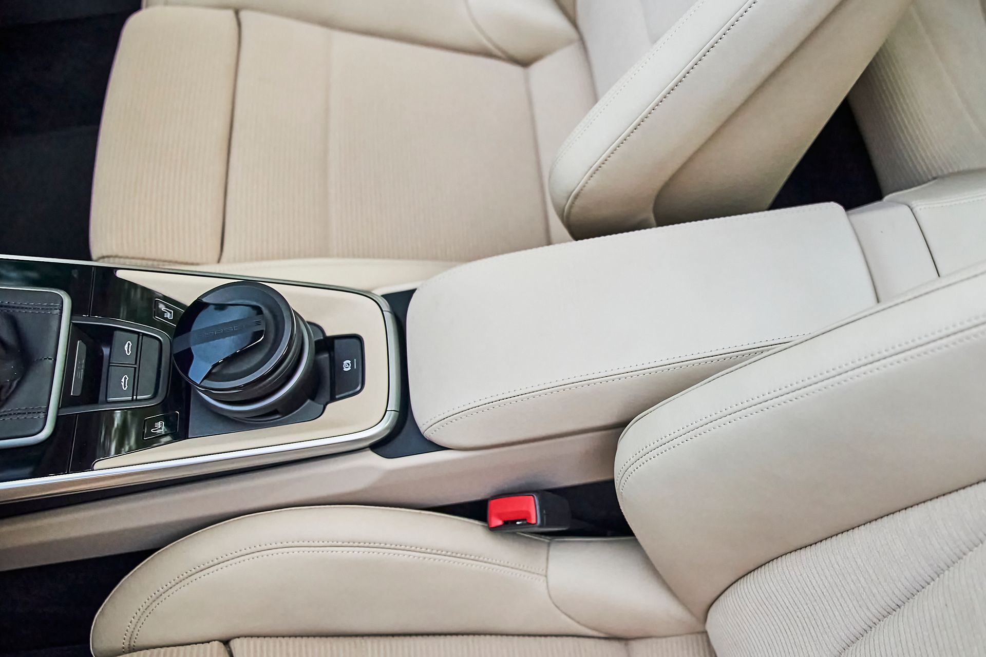 The interior of a car with white leather seats and a center console