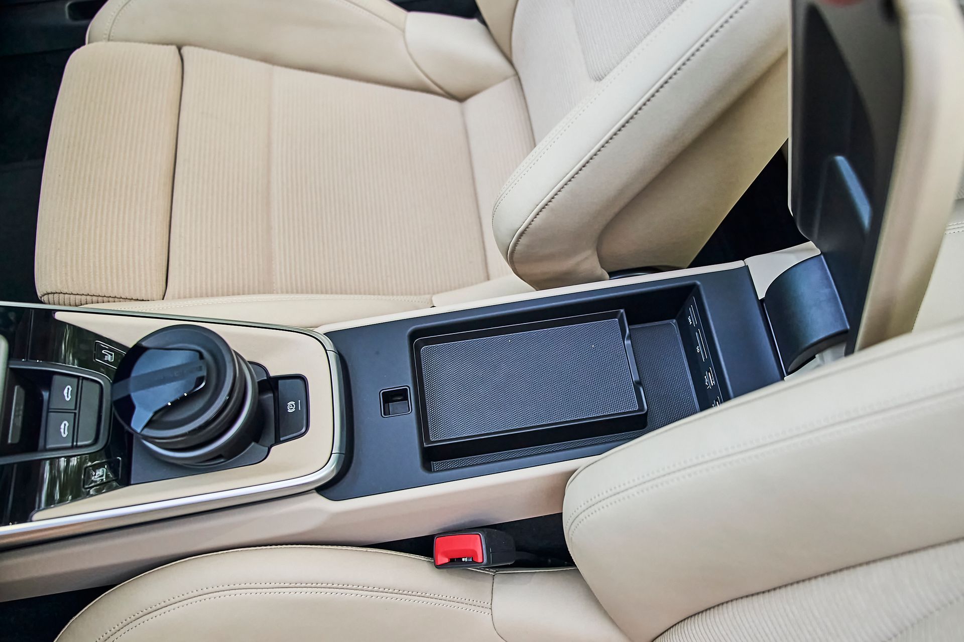 A close up of a car 's center console and seats