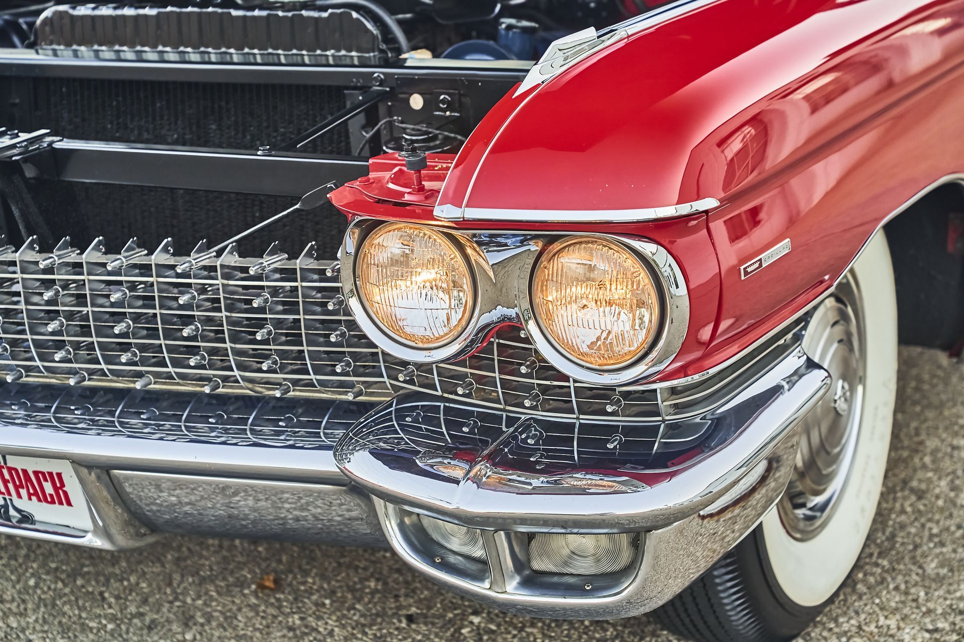 A red car with a license plate that says ' texas ' on it
