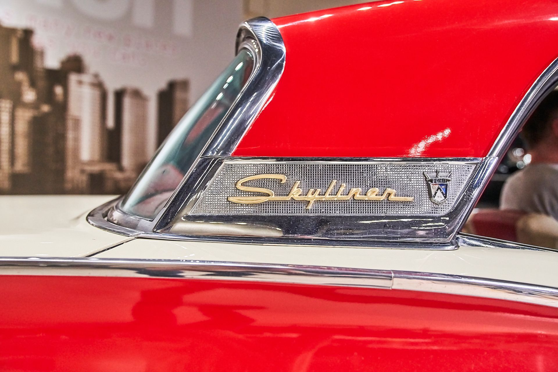 A red and white car with the word skyliner on the windshield.