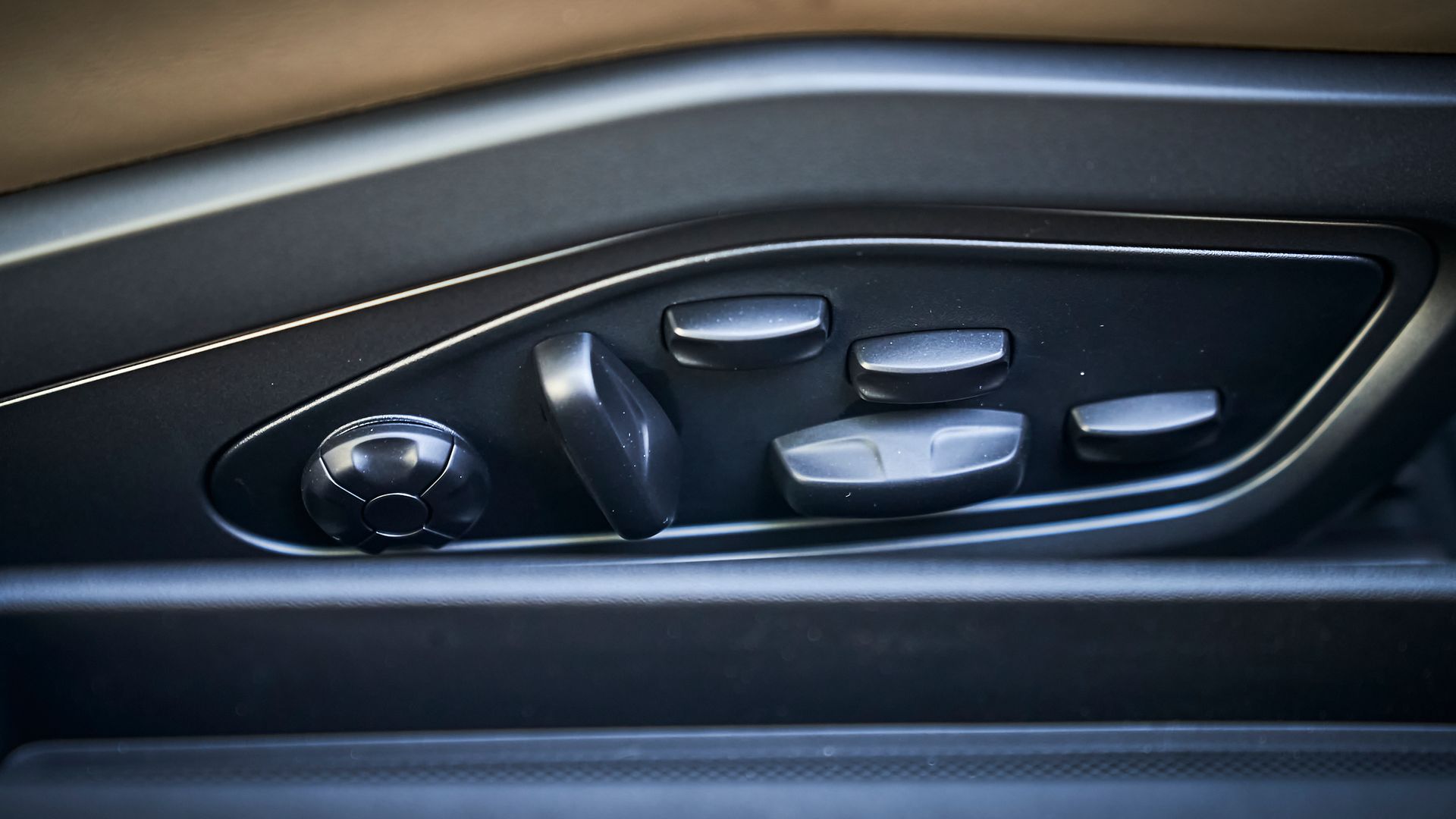 A close up of a car door with buttons on it.