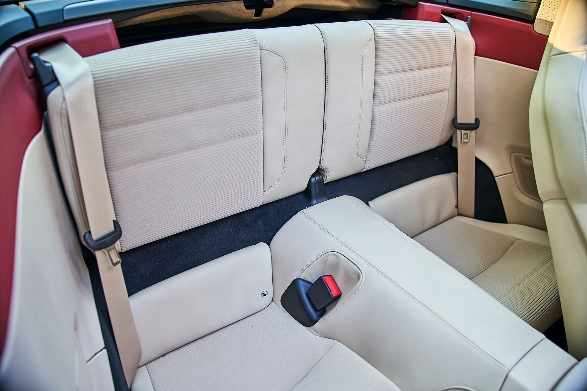 The back seat of a car with a red roof