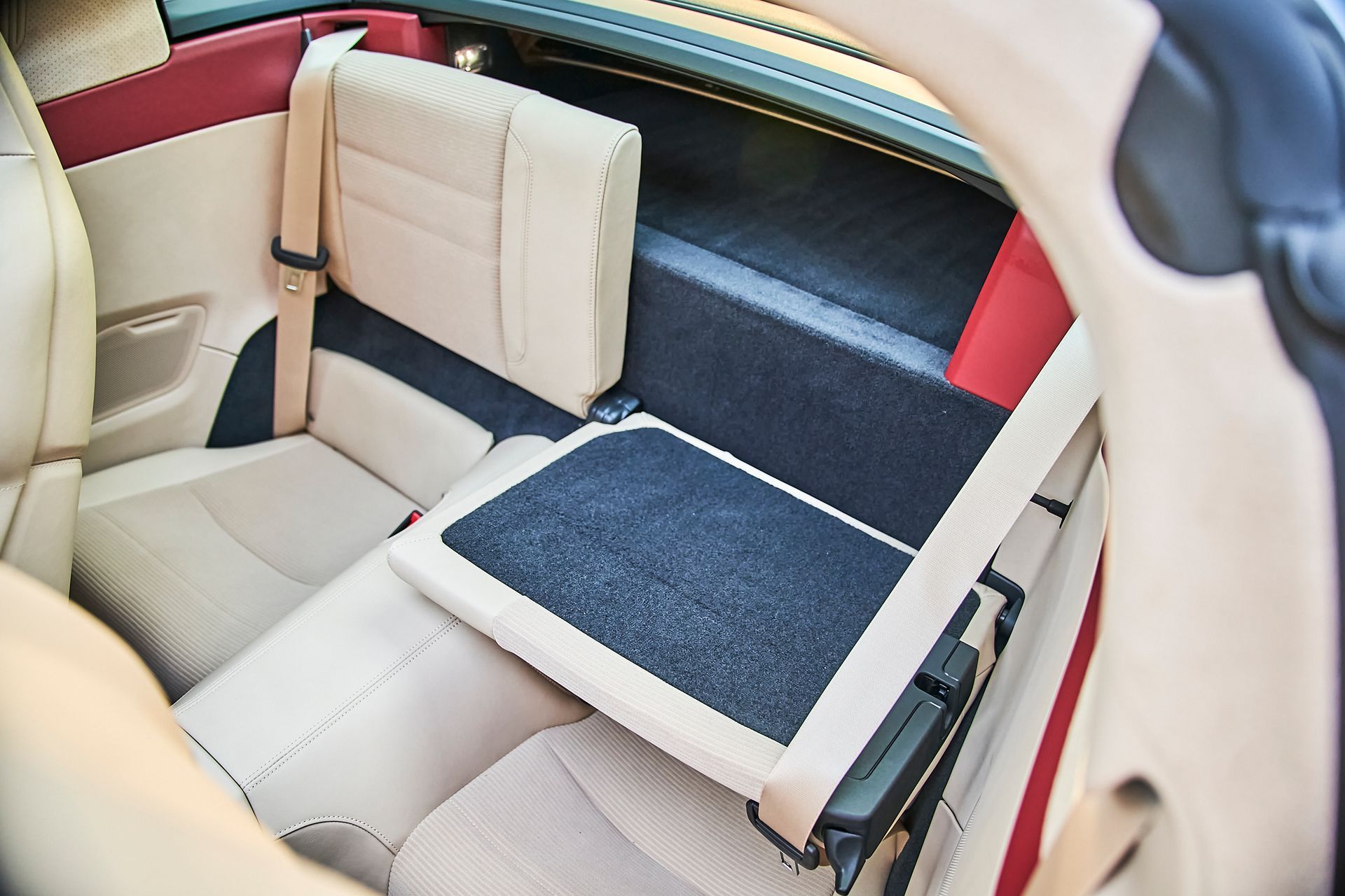 The back seat of a car with the seat folded up