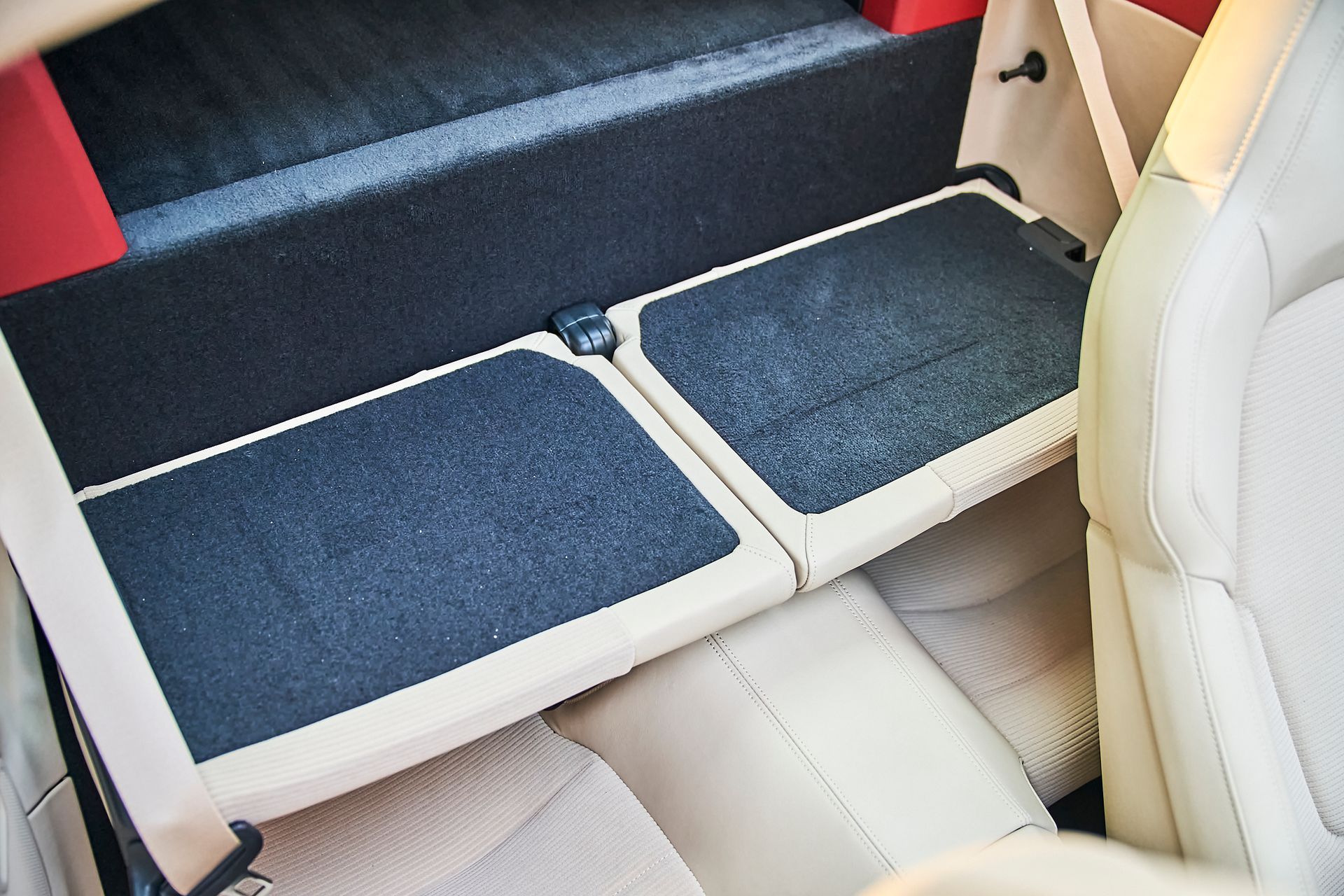 The back seat of a car with the trunk open