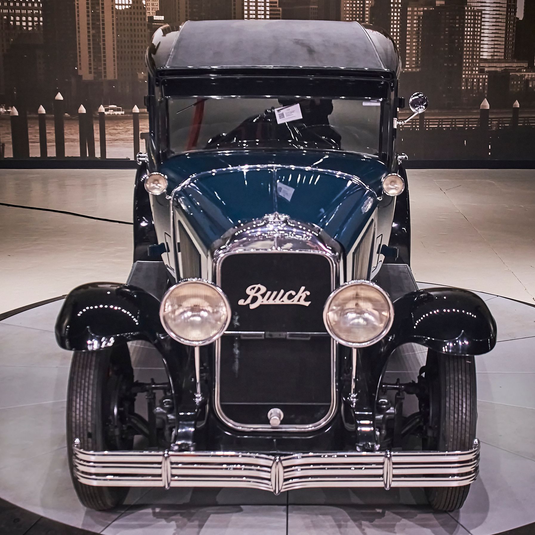 An old buick car is on display in a showroom