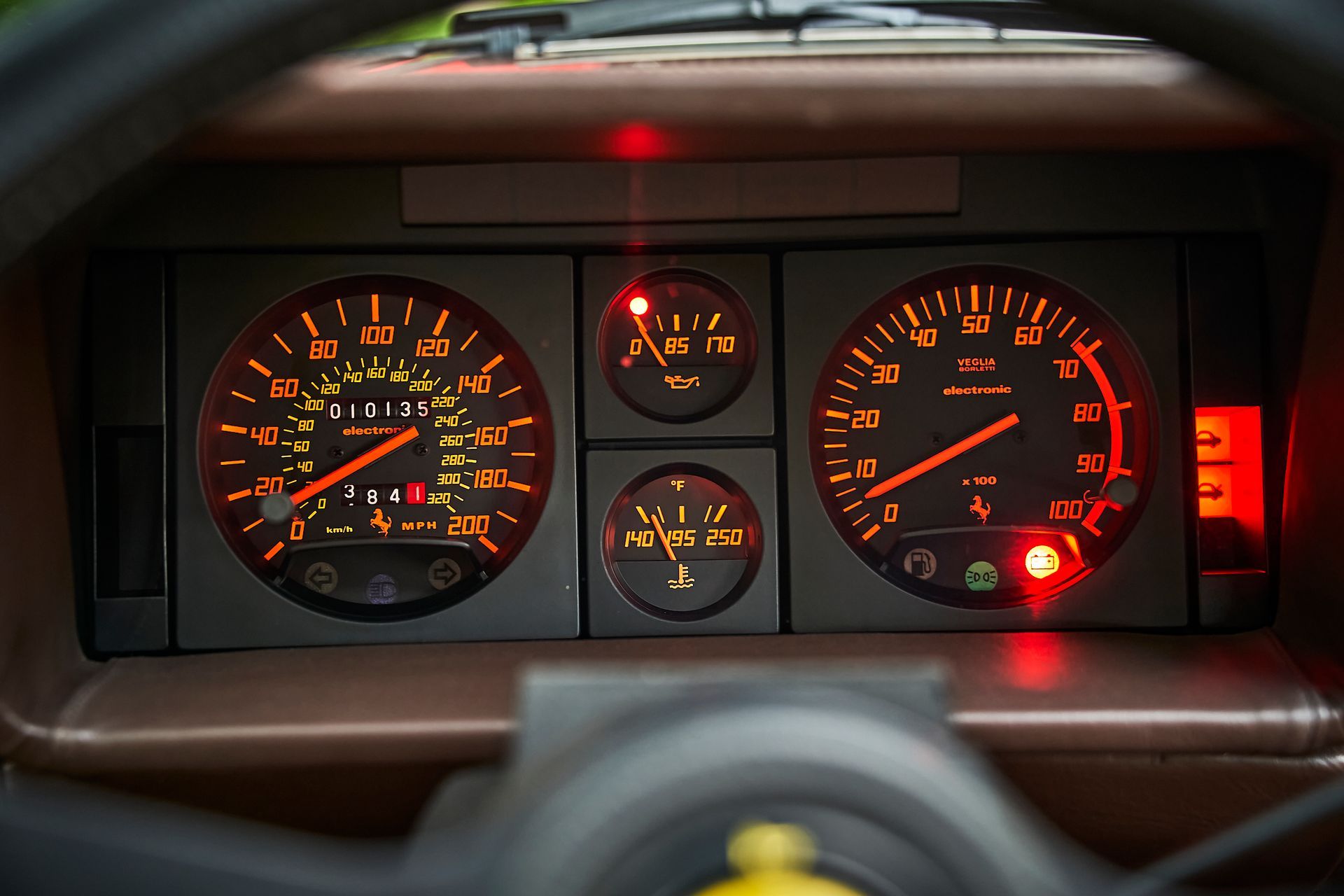 A close up of a car dashboard with a steering wheel