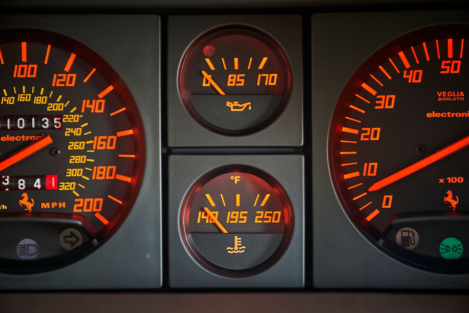 A close up of a car dashboard with a speedometer and other gauges