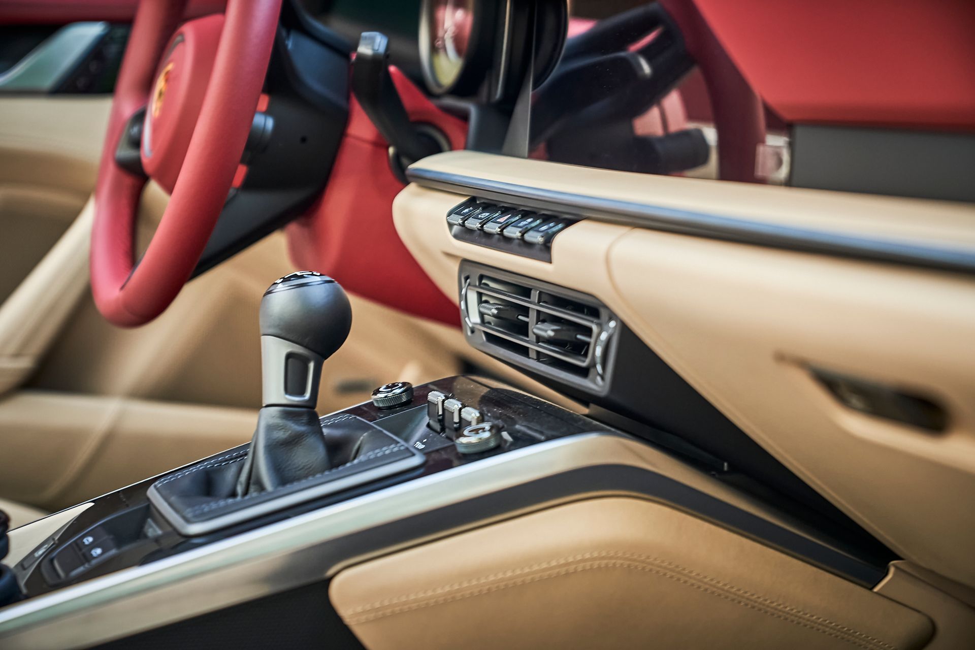 A close up of the interior of a car with a red steering wheel.