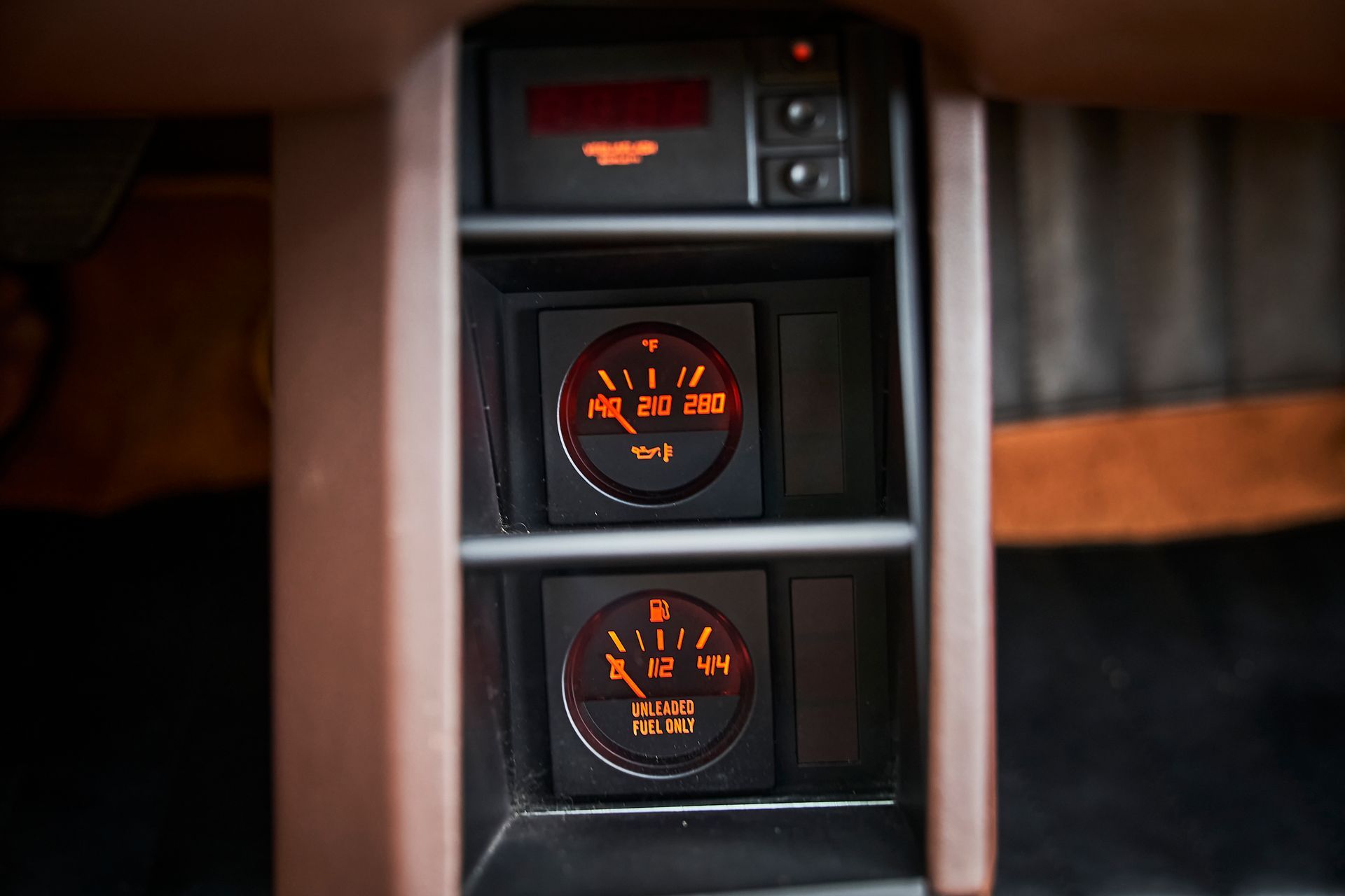 A close up of a car dashboard with three gauges.