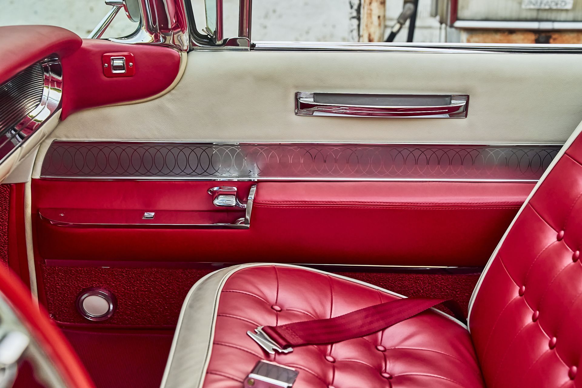 The inside of a red car with a red seat belt