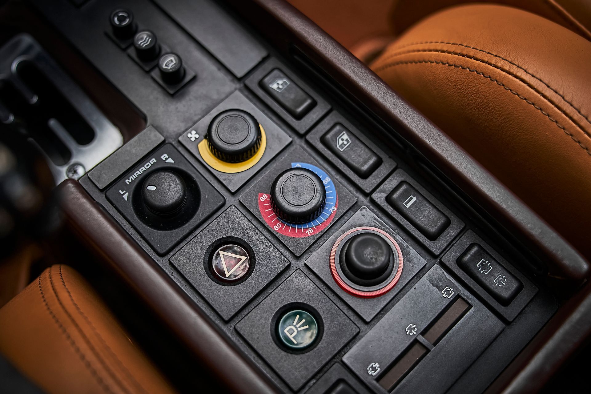 A close up of a car dashboard with a lot of buttons and knobs.