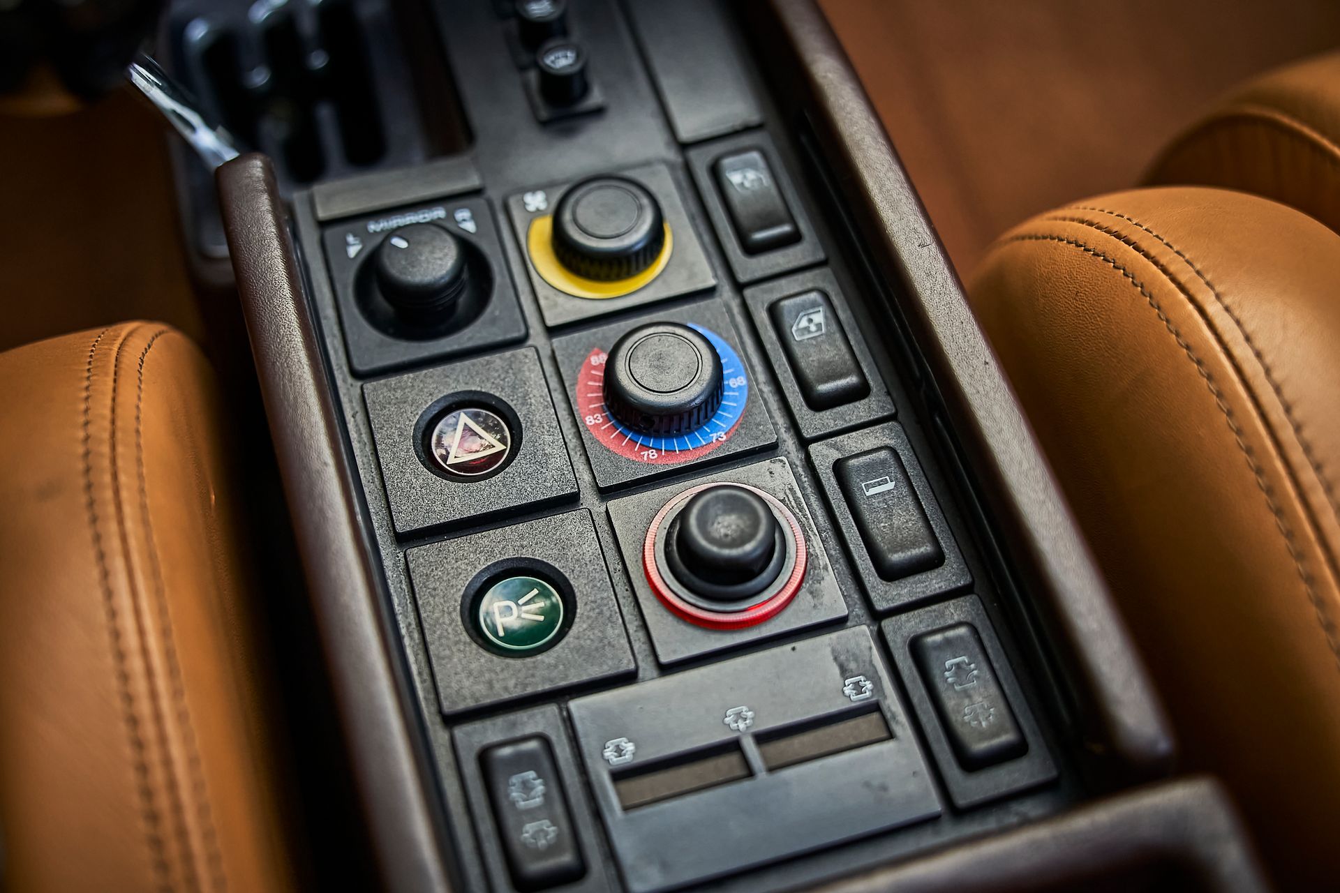 A close up of a dashboard in a car with buttons and knobs.