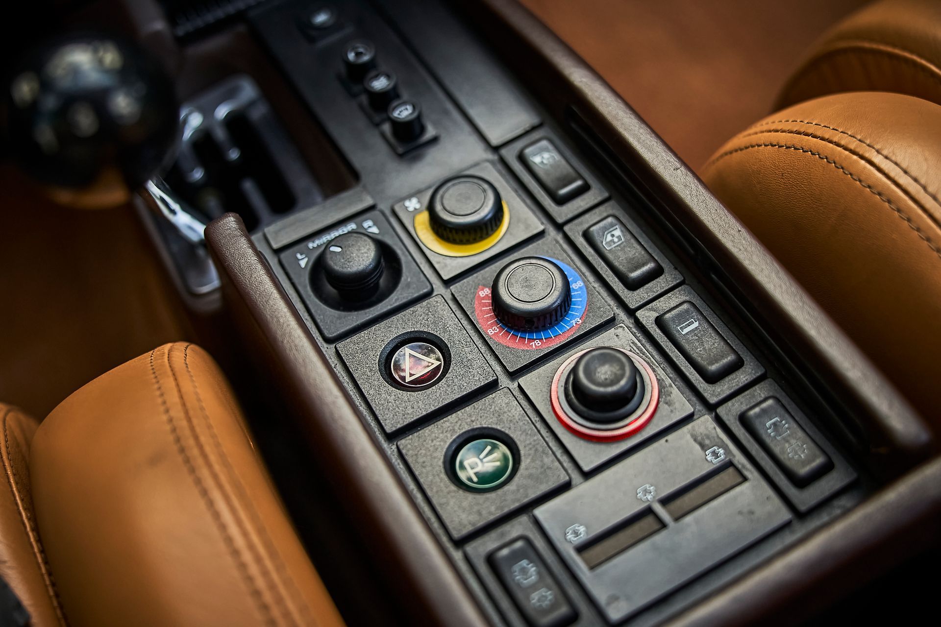 A close up of a car dashboard with a lot of buttons and knobs.