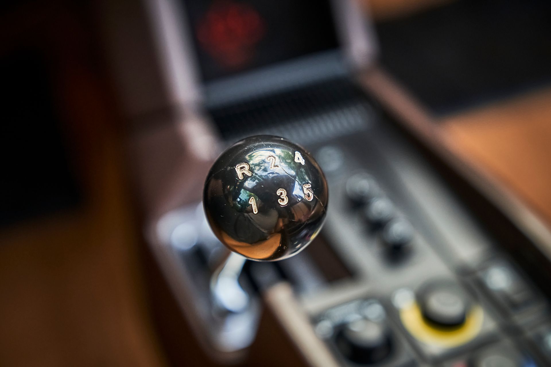 A close up of a shift knob on a car.