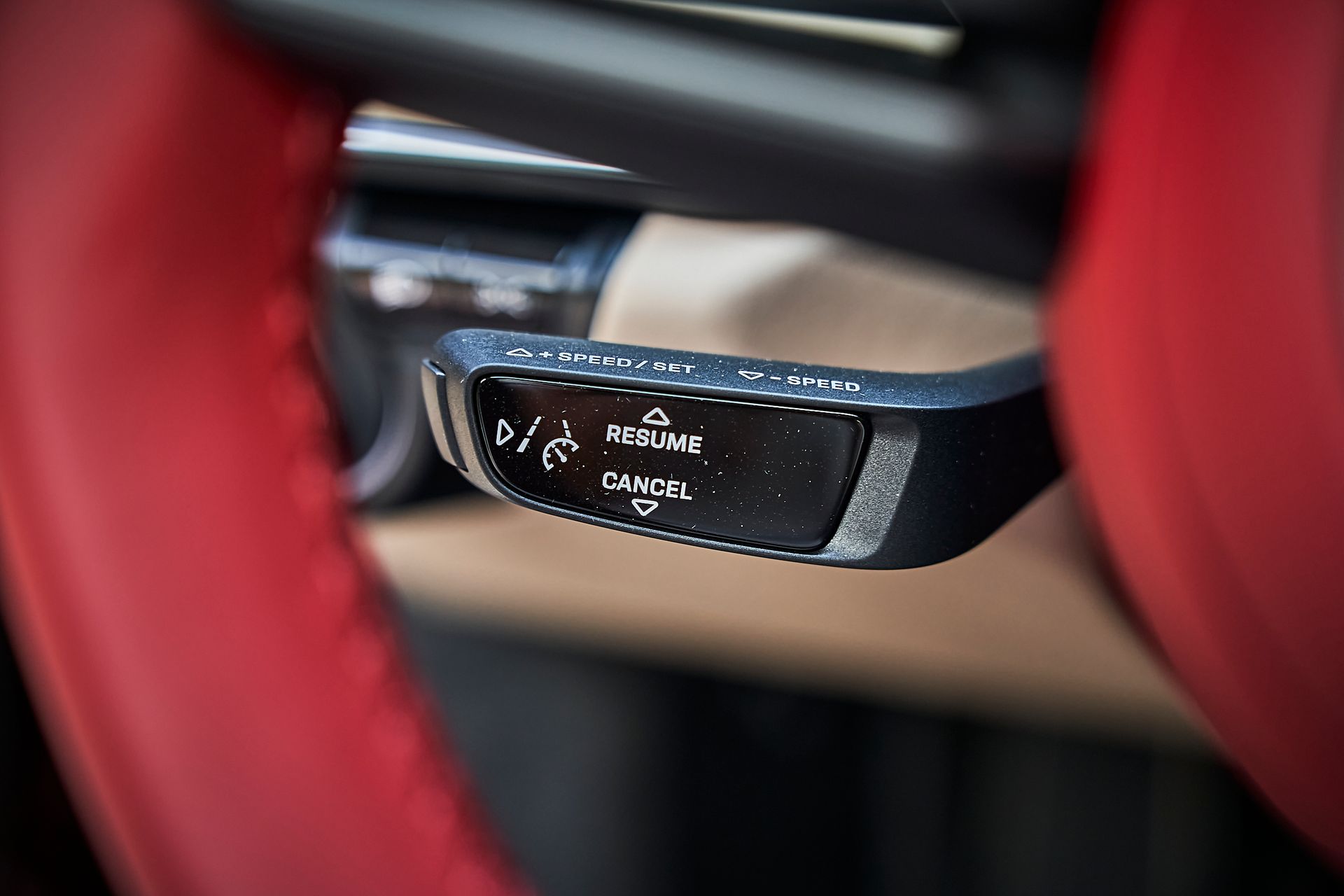 A close up of a steering wheel control in a car.
