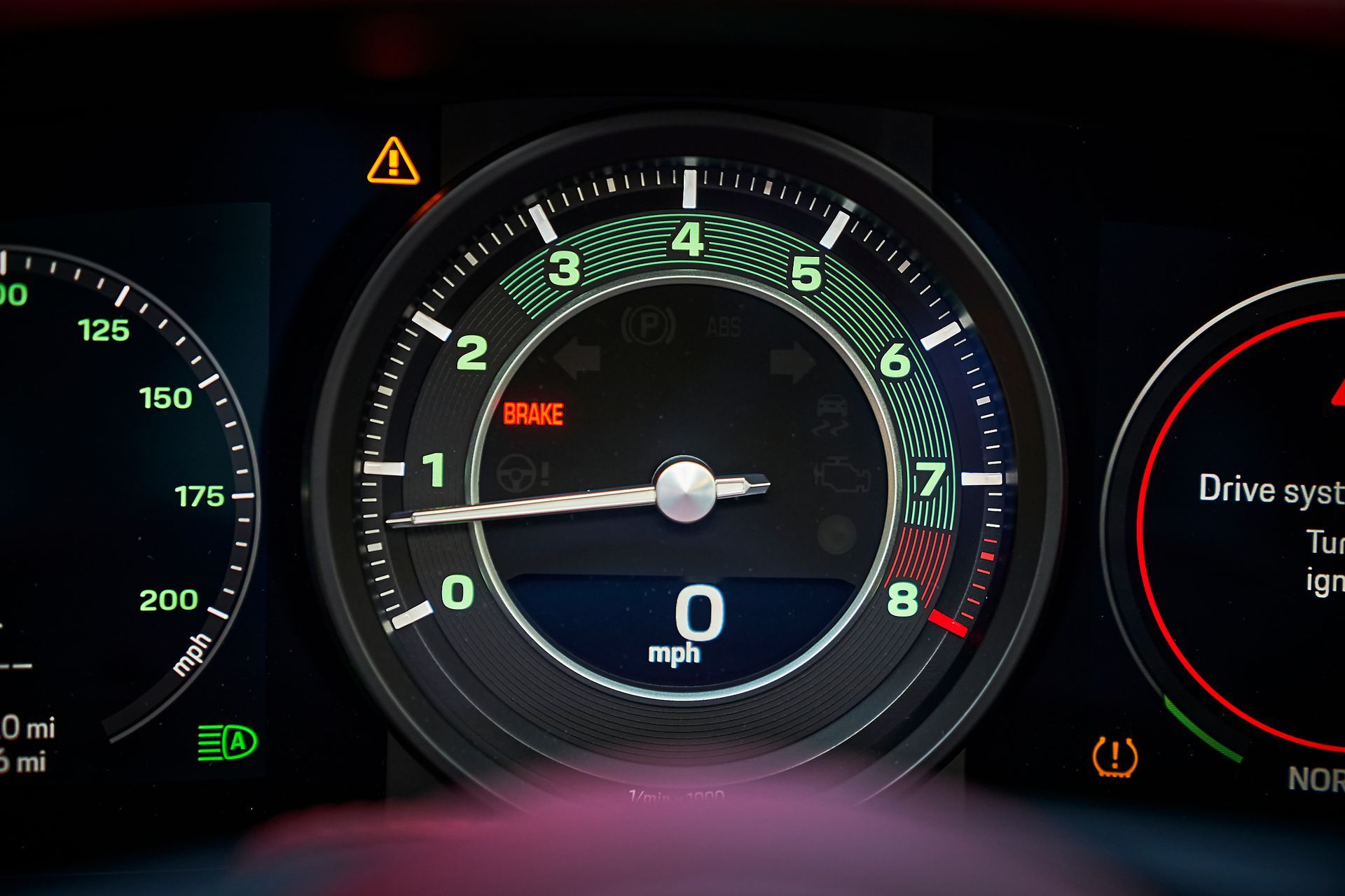 A close up of a car dashboard with a speedometer and other gauges