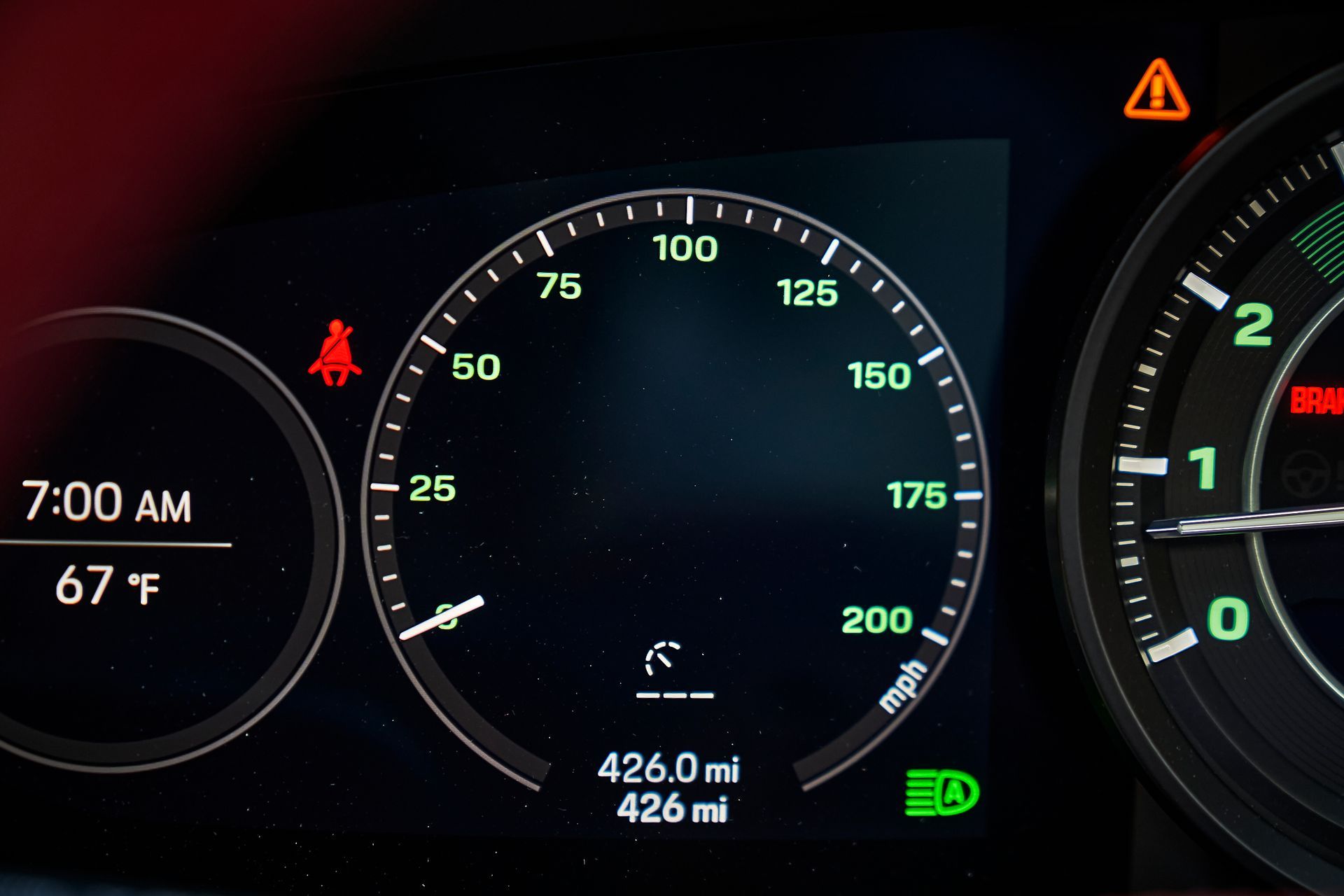 A close up of a car dashboard with a temperature of 67 degrees
