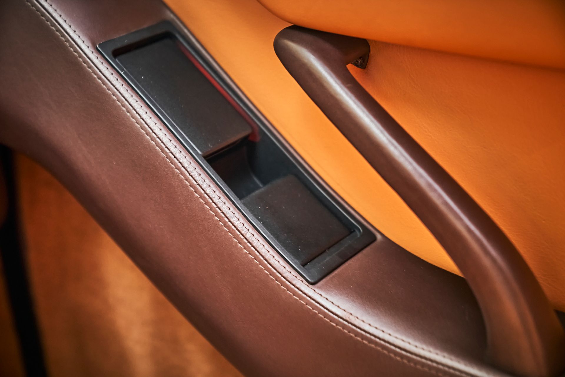 A close up of a door handle in a car