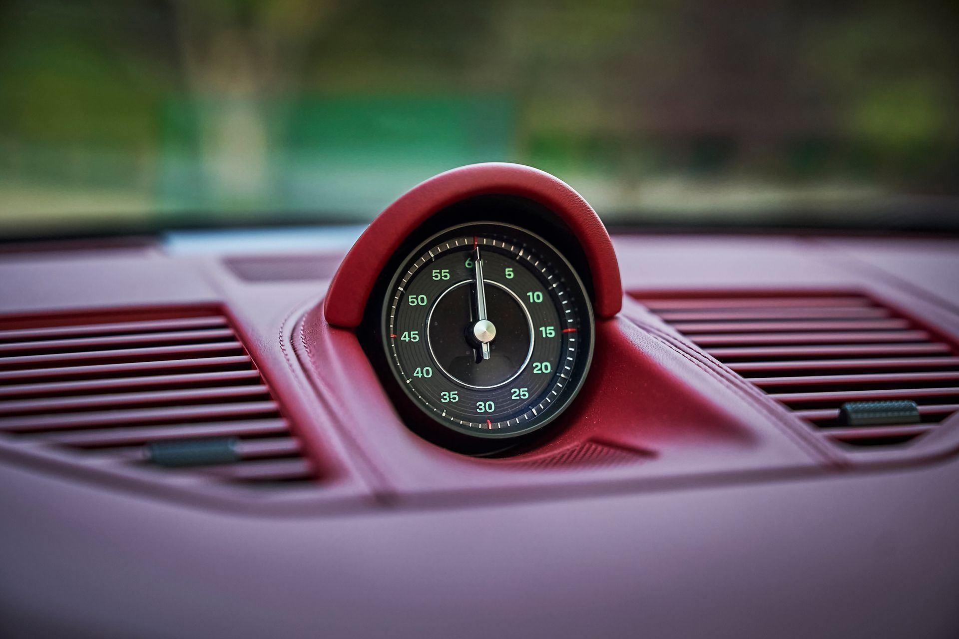 A close up of a clock on the dashboard of a car.