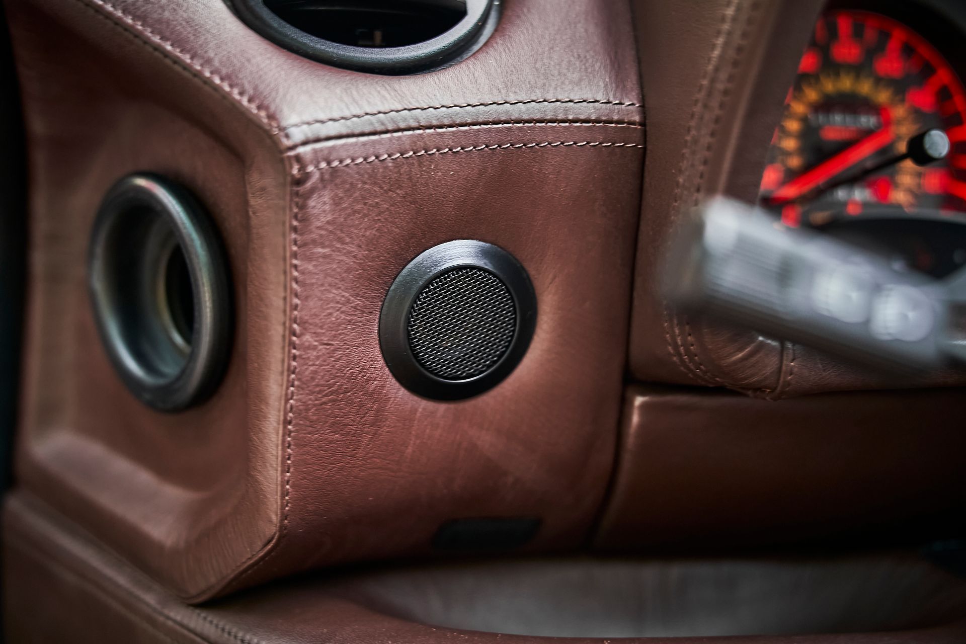 A close up of a speaker in a car.