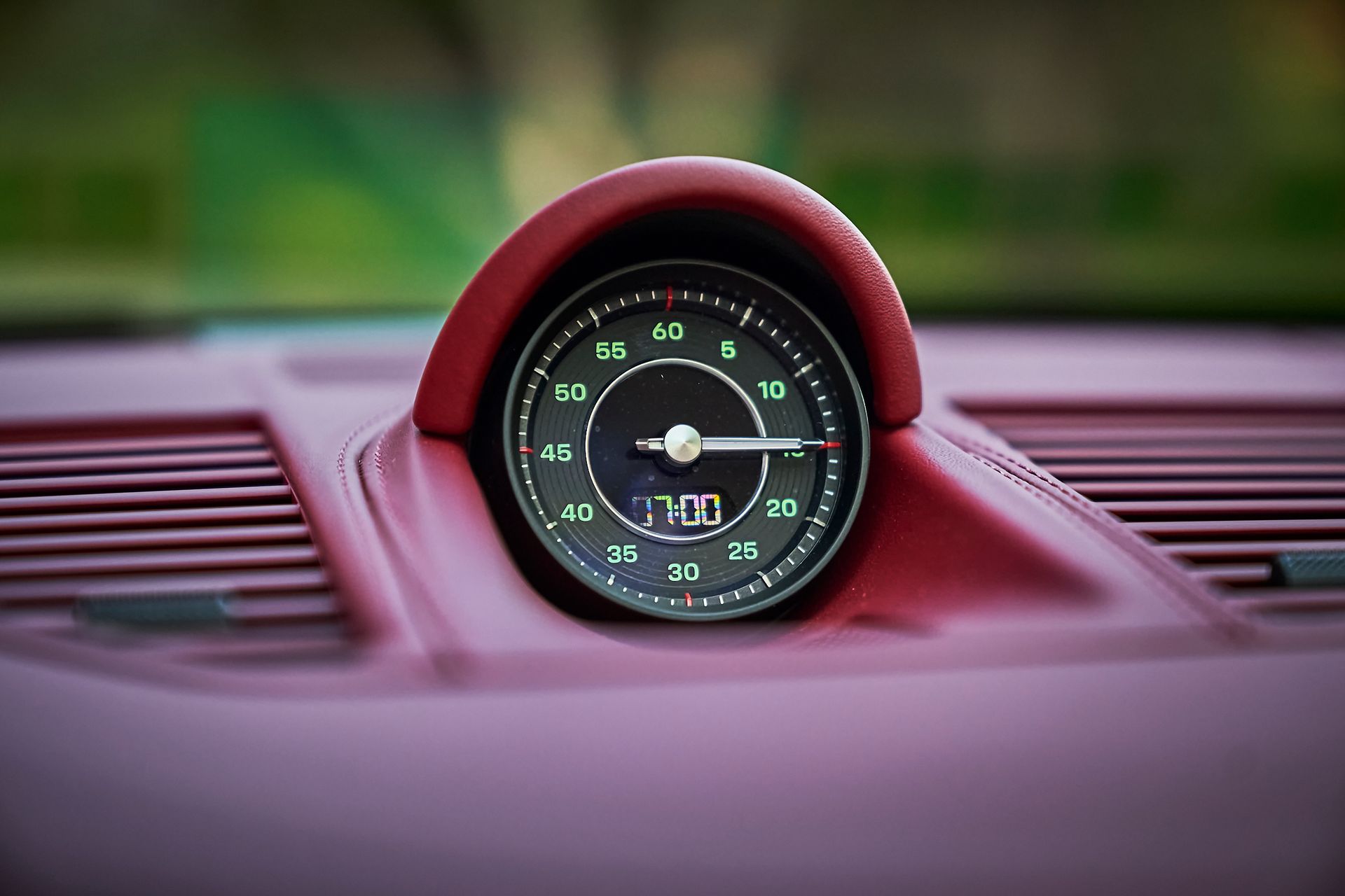 A close up of a clock on the dashboard of a car.