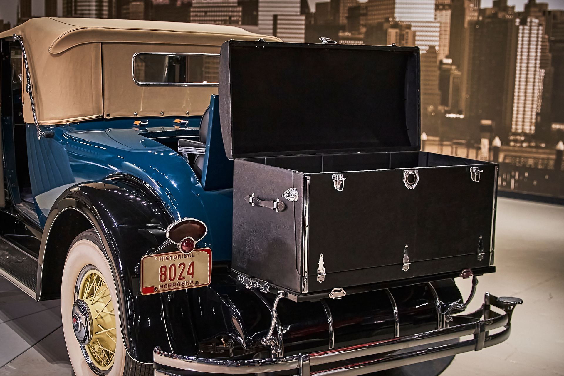 An old car with a license plate that says 8024