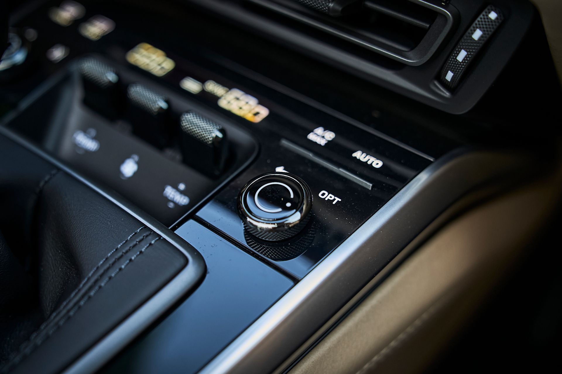 A close up of a car dashboard with a button that says out