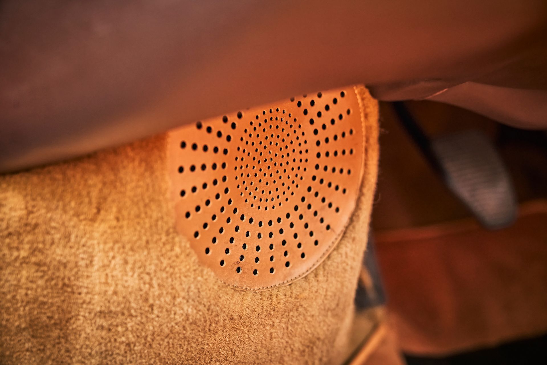 A close up of a speaker in a car.