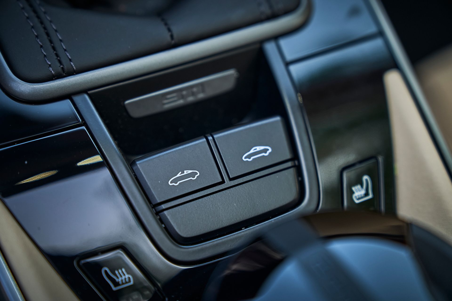 A close up of a car dashboard with a few buttons on it.